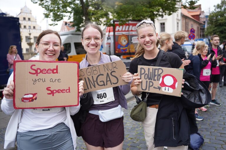 Fans mit Schildern wie „Speed, you are Speed“ und „Power up“, hinten ein Lkw von Hiller Spedition & Logistik